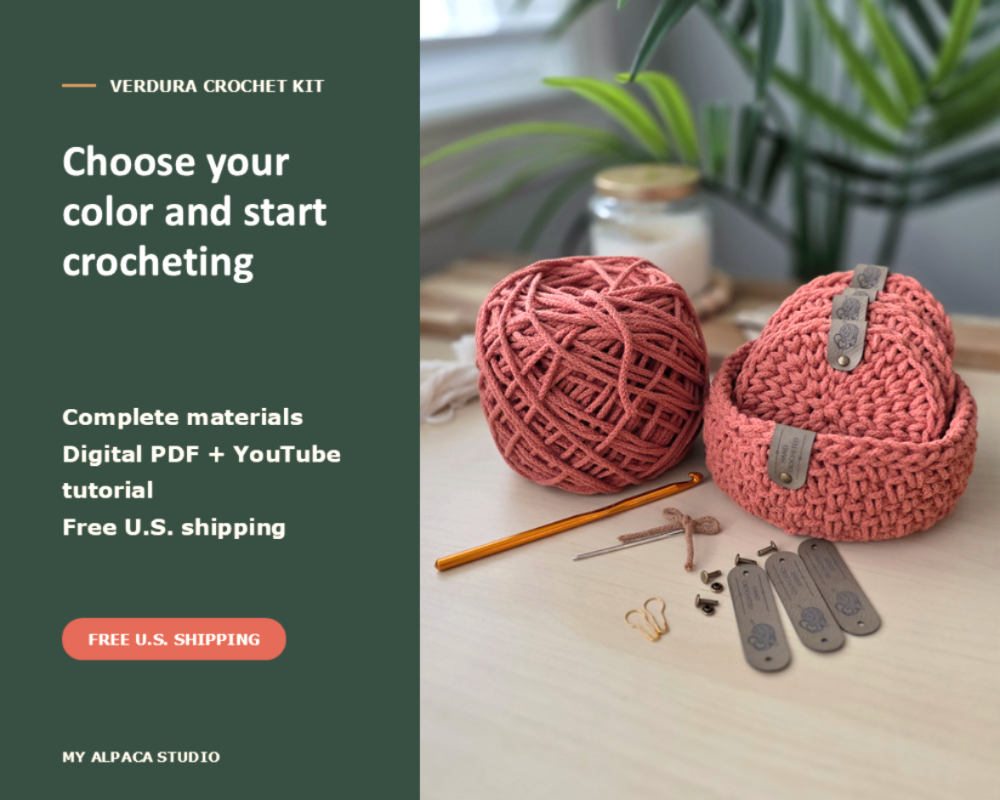 Promotional graphic for the Verdura Crochet Kit by My Alpaca Studio, featuring a dark green text panel on the left and a styled flat-lay of crochet materials on a light wood surface on the right, including a coral-pink yarn ball, crocheted basket, crochet hook, and metal clips.